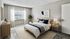 Bright and modern bedroom with minimalist decor, featuring a cozy bed, stylish nightstands, and a lush potted plant by the window.