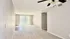 Bright and spacious living room with large window, elegant ceiling fan, and neutral tones, offering a cozy and inviting atmosphere.
