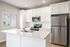 Modern kitchen with sleek stainless steel appliances, elegant white cabinetry, and a stylish breakfast island.