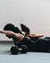 Focused women in a sleek gym engaging in a dynamic workout session with weights, emphasizing strength and determination.