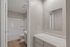 Chic bathroom with elegant marble countertops, modern fixtures, and a pristine bathtub.