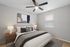 Elegantly decorated bedroom with cozy bed, modern bedside lamps, and abstract wall art creating a serene atmosphere.