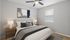 Inviting bedroom with modern decor, featuring a cozy bed, elegant lamps, and chic artwork, creating a relaxing sanctuary.