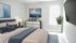 Bright and modern bedroom with elegant decor, featuring plush bedding, stylish artwork, and a cozy ambiance.