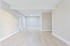 Bright and spacious living area with modern wood flooring and neutral walls, ideal for personalized styling.