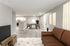 Virtually staged apartment showcasing a modern open-plan living area with hardwood floors, cozy leather sofa, chic dining space, and a contemporary kitchen.