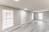 Bright and inviting apartment entry with natural light and stylish wood flooring.