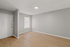 Bright and inviting apartment entryway with modern grey walls and sleek hardwood floors.