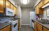 Modern kitchen with elegant wooden cabinets, sleek appliances, and ample counter space, perfect for culinary enthusiasts.
