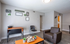 Contemporary living room with stylish decor, comfortable furnishings, and a warm, inviting ambiance.