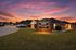 Charming Patterson Place Apartments showcasing scenic sunset view, inviting driveway, and cozy brick buildings.
