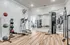 Spacious gym with state-of-the-art fitness equipment and large mirrors.
