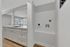 Sleek, modern kitchen with a bright, open layout featuring pristine white cabinetry, stylish sink, and ample natural light.
