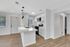 Bright and modern kitchen with sleek appliances, elegant countertops, and inviting wooden floors.