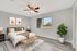 Inviting bedroom with modern decor, featuring a cozy bed, stylish wall art, and a tranquil view through a large window.