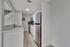 Modern kitchen with sleek stainless steel appliances, elegant backsplash, and stylish open-concept design.