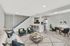 Modern open-plan living space with elegant seating area, contemporary kitchen, chic dining set, and stylish staircase.
