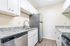 Bright and modern kitchen featuring sleek stainless steel appliances, elegant granite countertops, and crisp white cabinetry.