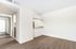 Sleek modern apartment with light wood flooring, open space design, and minimalist countertops.