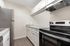 Modern kitchen design featuring sleek stainless steel appliances, elegant granite countertops, and ample white cabinetry.