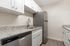 Modern kitchen featuring sleek stainless steel appliances, elegant granite countertops, and bright white cabinetry for a sophisticated look.