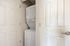 Convenient in-unit laundry with a sleek stacked washer and dryer in a compact closet space.