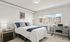 Bright and modern bedroom with stylish decor, featuring a large window with a mountain view, cozy bed, and convenient workspace.