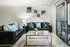 Living room with two leather couches, glass coffee table, and sliding glass patio door