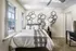 Bedroom with modern wall decor, full sized bed, closet and study desk