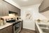Kitchen with hardwood floors, stainless steel appliances, granite counter tops, and modern wooden cabinets.