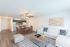 Living and Dining area with hardwood floors, beige walls, glass table, leather chairs, and a white couch.