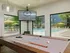 Billiard table with large windows and tv in background.