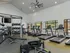 Fitness center with various cardio equipment and weights.