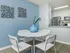 Dining area with small circular table and four chairs.
