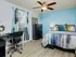 Bedroom with ceiling fan and furniture.