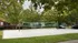 Sand volleyball court with trees in background.