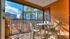 Screened patio with small table and four chairs.