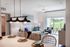 Kitchen with breakfast island, stainless appliances, pendant lights.