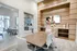Conference room with meeting table, wall hanging screen.