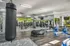 Fitness center with punching bag, cardio, and strength equipment. Two TVs are mounted on the wall.