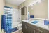 Bathroom with granite countertop and blue accents