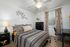 Bedroom with ceiling fan, window, furniture.