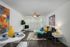Dining and living room area.  Table and chairs, sofa and chair in background.