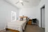 Carpeted bedroom with bed with gray bedspread
