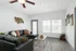 Living room area with large window and door out to balcony