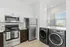 Kitchen with stainless steel appliances and washer dryer