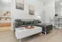 Couch with kitchen and bedroom in background