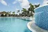 Pool with waterfall and lounge chairs, lanai in background