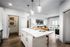 Kitchen with granite countertops and living room