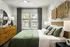 Bedroom with green bed and dresser